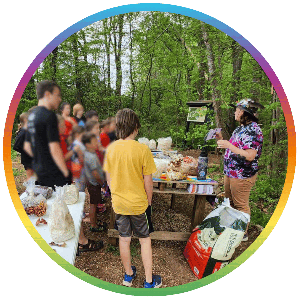 Group of people gathered learning how to garden with mushrooms